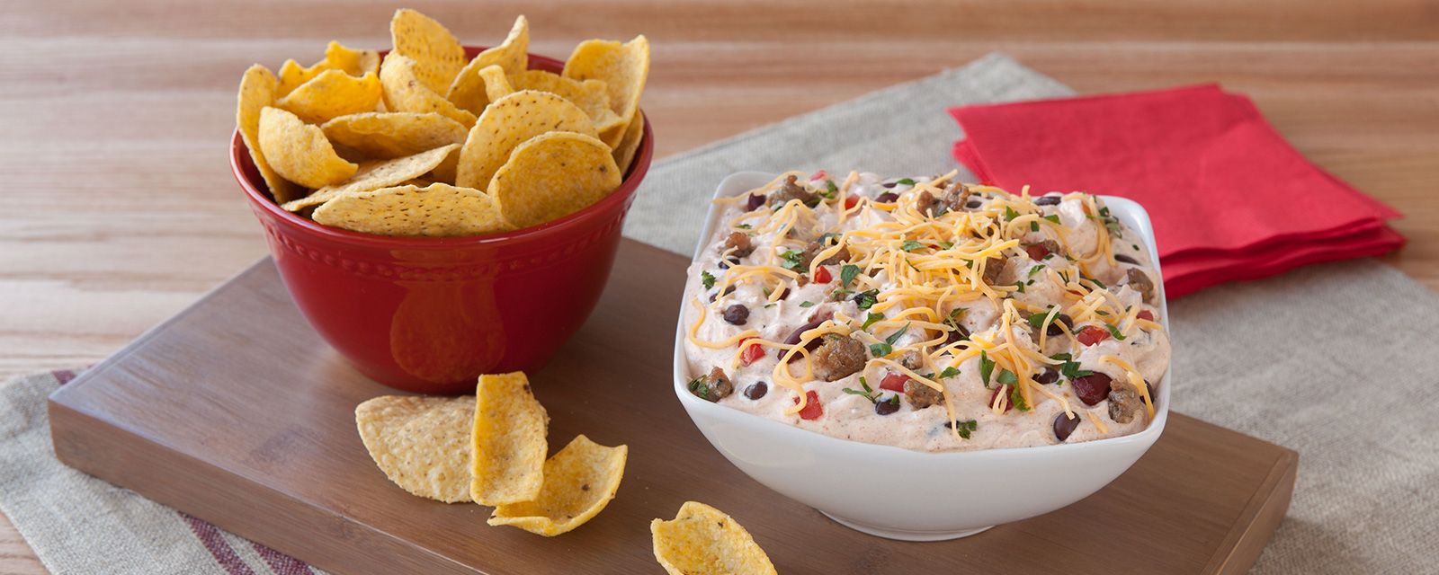 Bowl of Hidden Valley Beef and Bean Chili Dip next to bowl of torilla chips