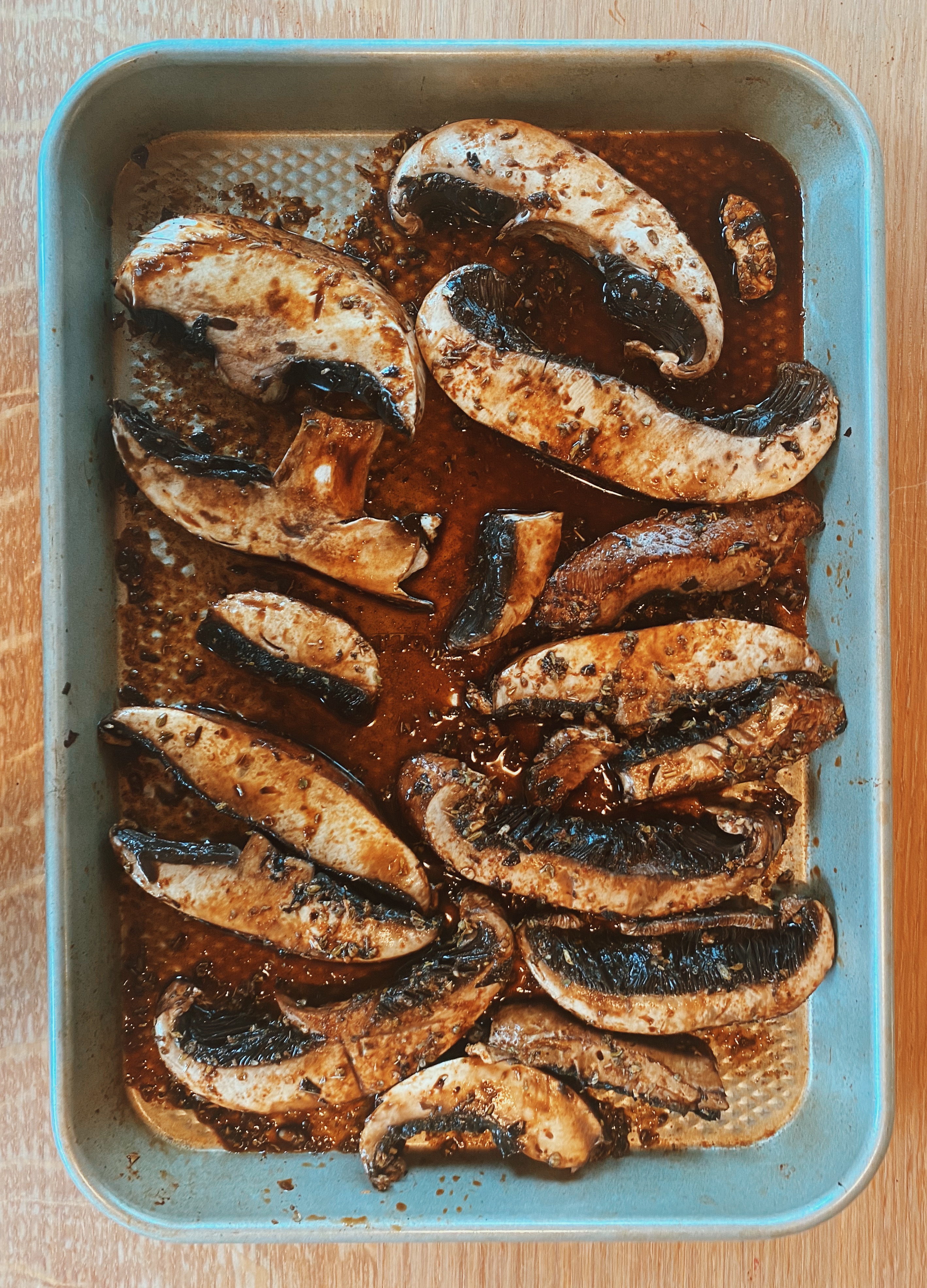 Picture showcasing mushrooms in a pan with ingredients mixed in.