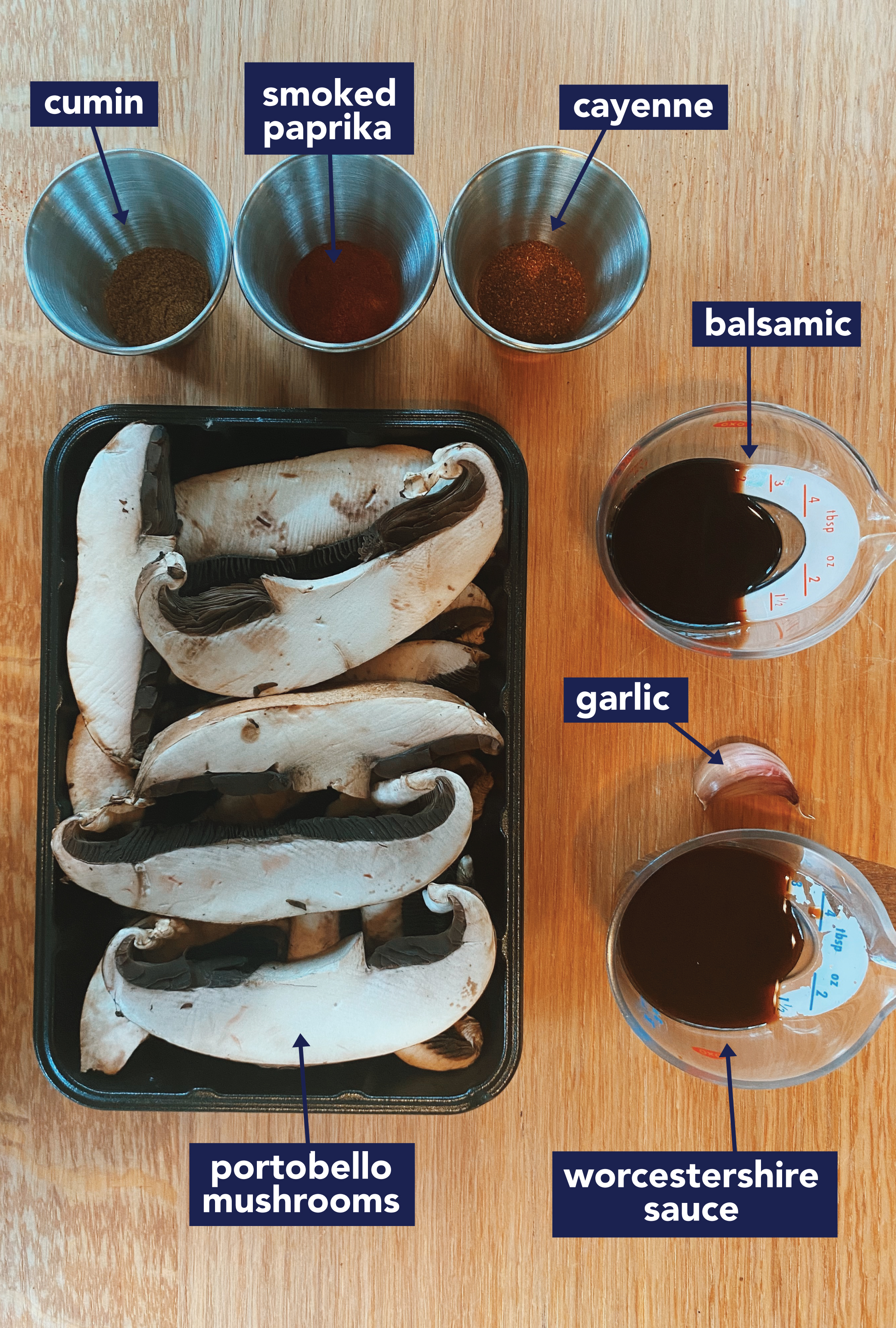 Image of ingredients on a table. Shows Cumin, spoked paprika, cayenne, balsamic garlic and mushrroms.